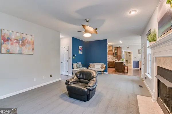 a living room with furniture and a fireplace