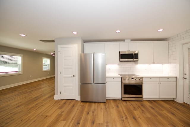 317 Pendleton Road Clemson, SC 29631 - Photo 16 of 36 A well-lit kitchen with sleek stainless steel appliances and abundant cabinetry, perfect for culinary endeavors.
