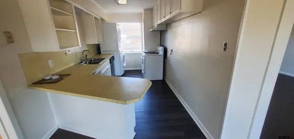 a view of a kitchen from a corridor