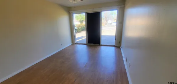 a view of wooden floor and windows in a room