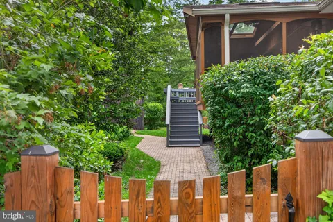 a wooden bench sitting in front of a house