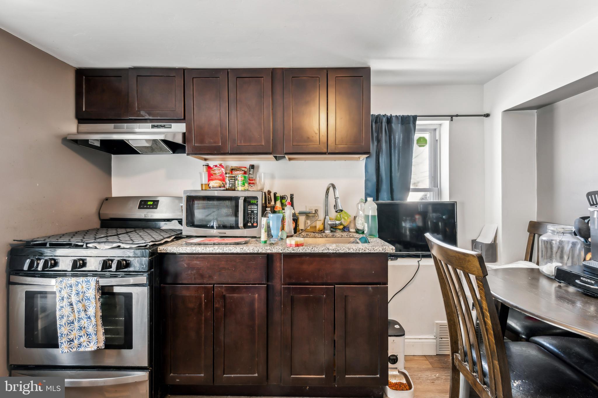 200 East Washington Street Riverside, NJ 08075 - Photo 23 of 31 a kitchen with stainless steel appliances granite countertop a stove a sink dishwasher and cabinets with wooden floor