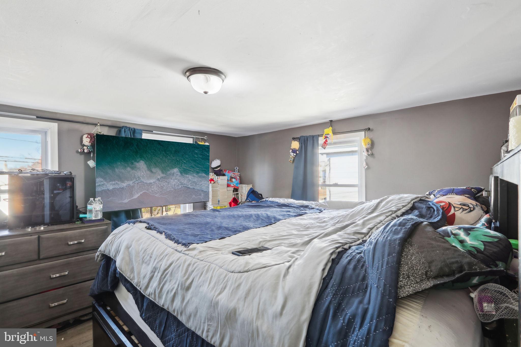 200 East Washington Street Riverside, NJ 08075 - Photo 24 of 31 a bedroom with a bed and large windows