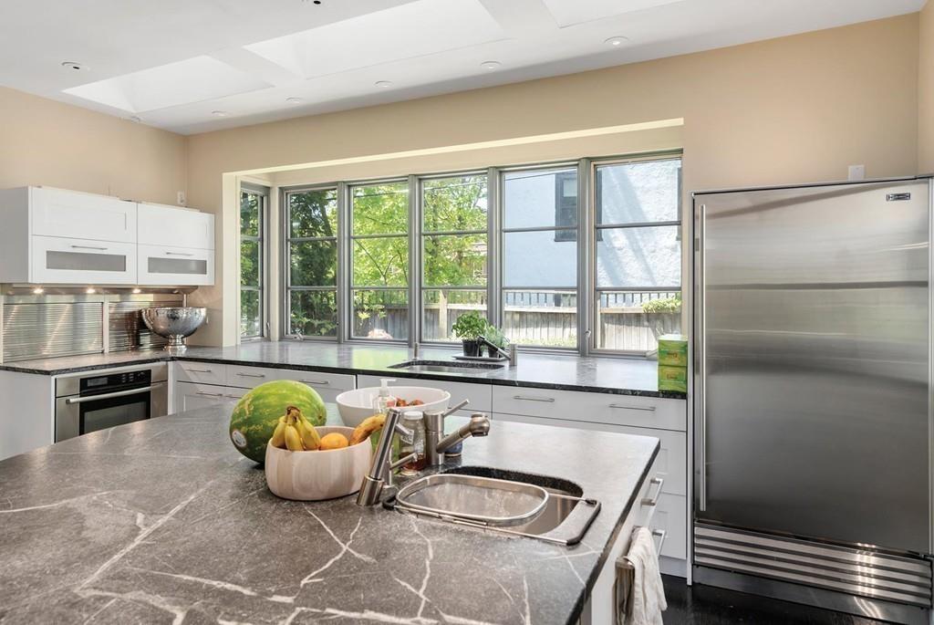 114 Naples Road Brookline, MA 02446 - Photo 11 of 24 a dining room with furniture and a large window