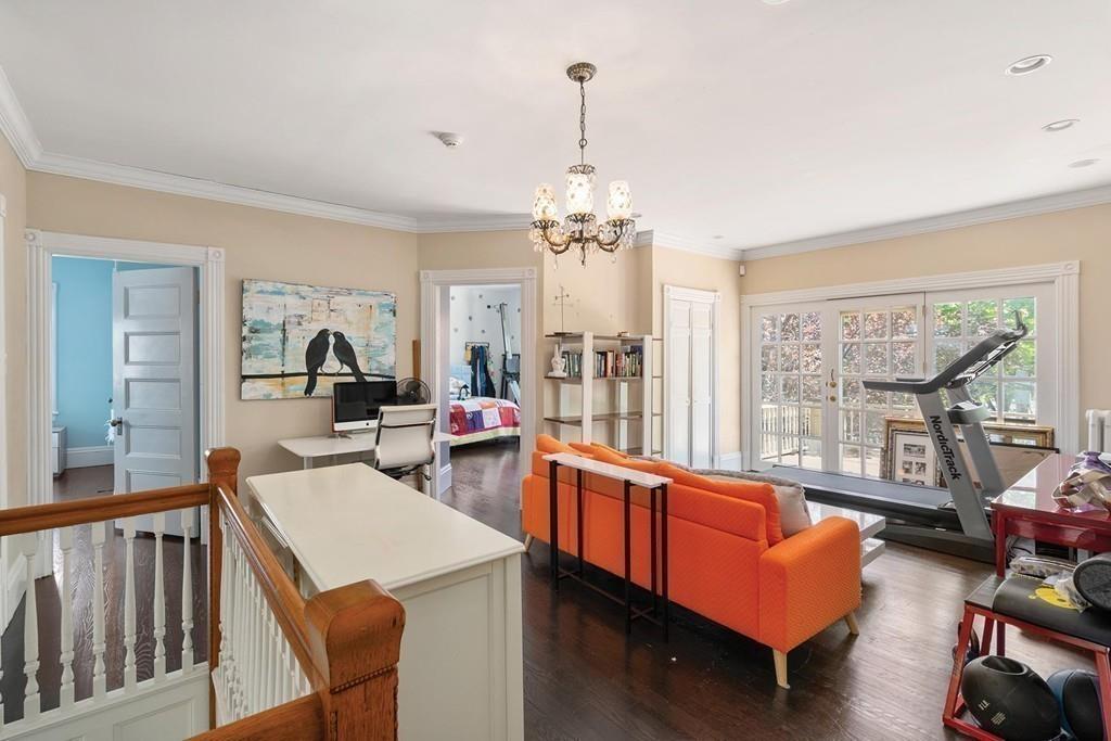 114 Naples Road Brookline, MA 02446 - Photo 13 of 24 a living room with furniture and a chandelier