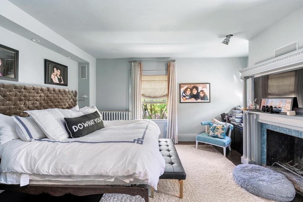 114 Naples Road Brookline, MA 02446 - Photo 14 of 24 a bedroom with a bed and a fireplace