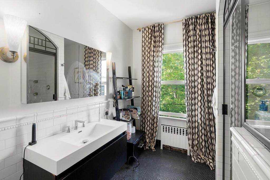 114 Naples Road Brookline, MA 02446 - Photo 15 of 24 a bathroom with a sink and a mirror