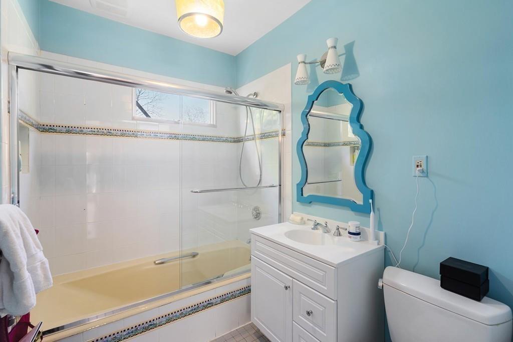 114 Naples Road Brookline, MA 02446 - Photo 19 of 24 a bathroom with a sink and mirror with bathtub