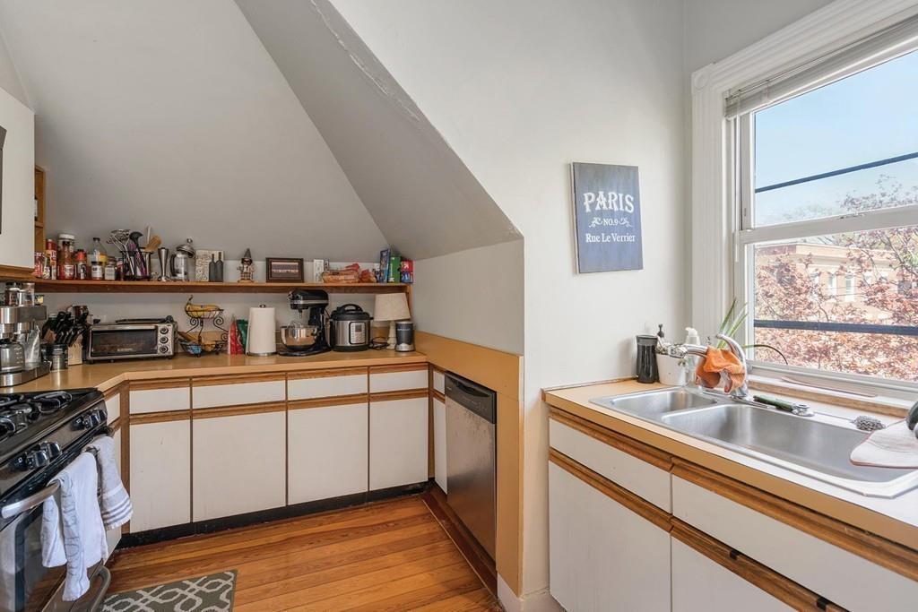 114 Naples Road Brookline, MA 02446 - Photo 21 of 24 a kitchen with stainless steel appliances granite countertop a sink and cabinets