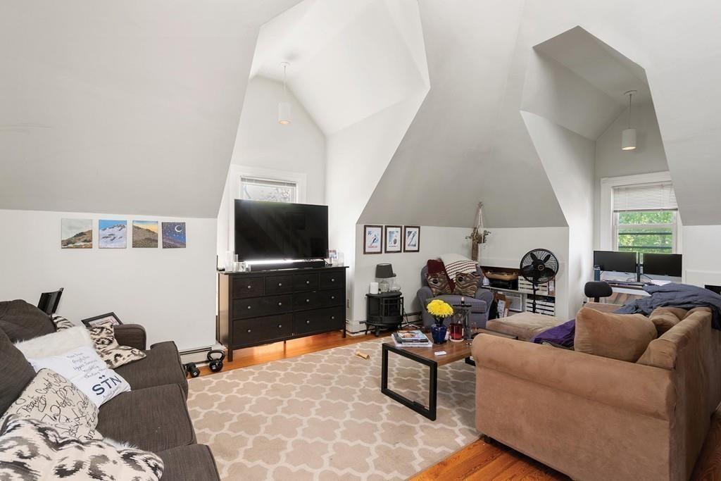 114 Naples Road Brookline, MA 02446 - Photo 22 of 24 a living room with furniture and a flat screen tv
