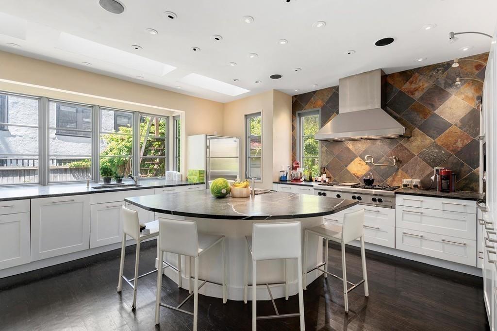 114 Naples Road Brookline, MA 02446 - Photo 10 of 24 a kitchen with stainless steel appliances granite countertop a stove and white cabinets
