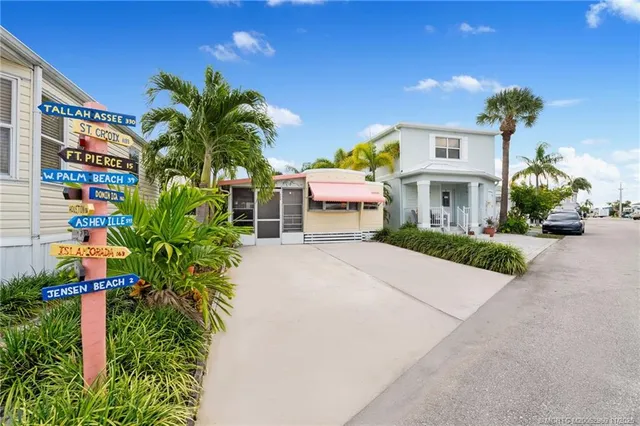 a front view of a multi story building with yard