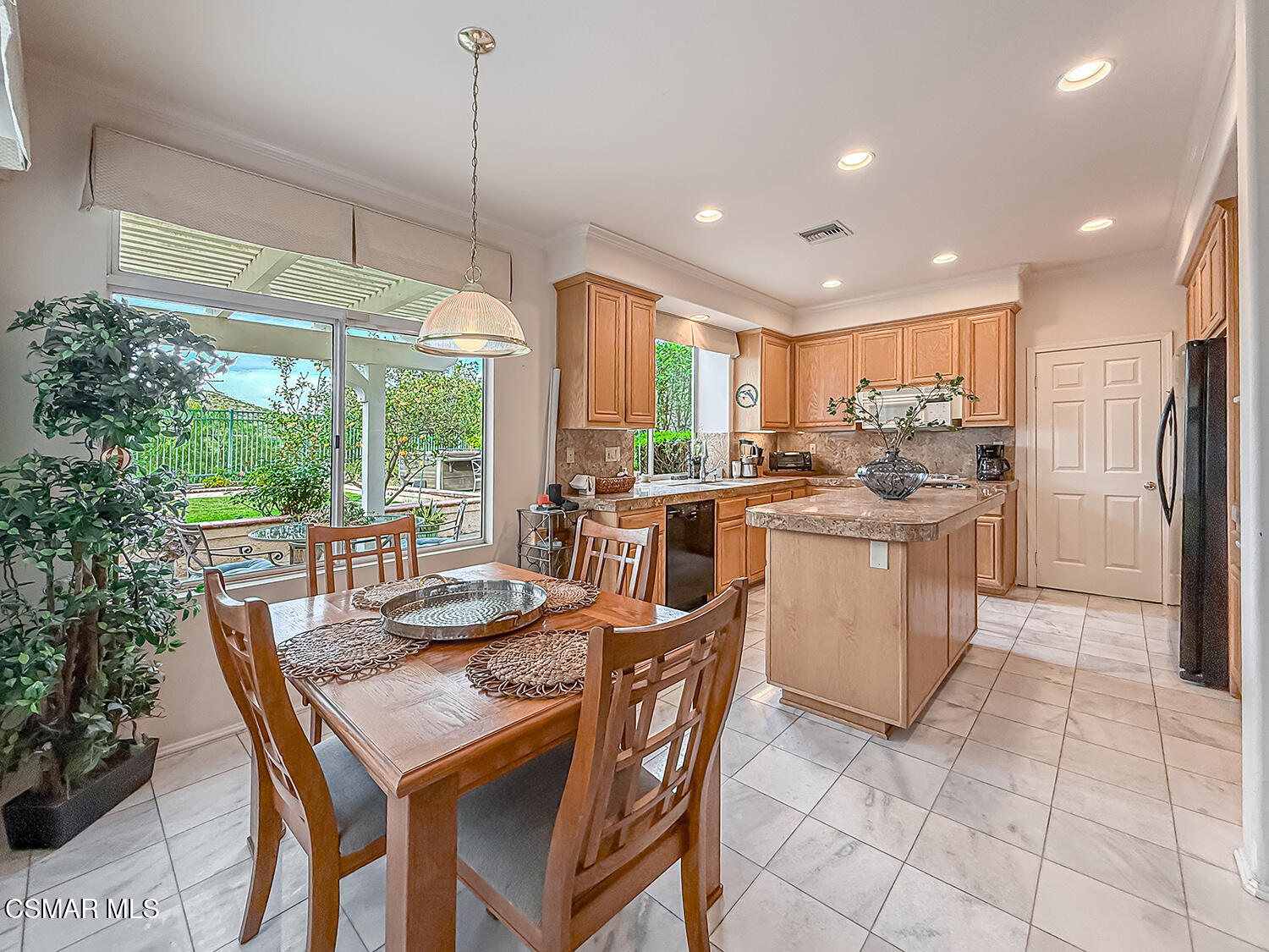 260 Sycamore Ridge Street Simi Valley, CA 93065 - Photo 21 of 59 a kitchen with stainless steel appliances granite countertop a table chairs and a refrigerator