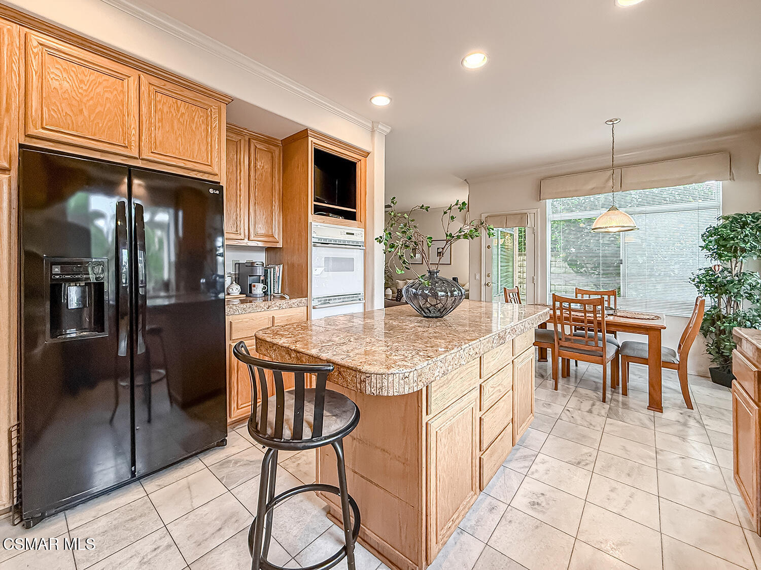 260 Sycamore Ridge Street Simi Valley, CA 93065 - Photo 26 of 59 a kitchen with stainless steel appliances granite countertop table chairs and a refrigerator