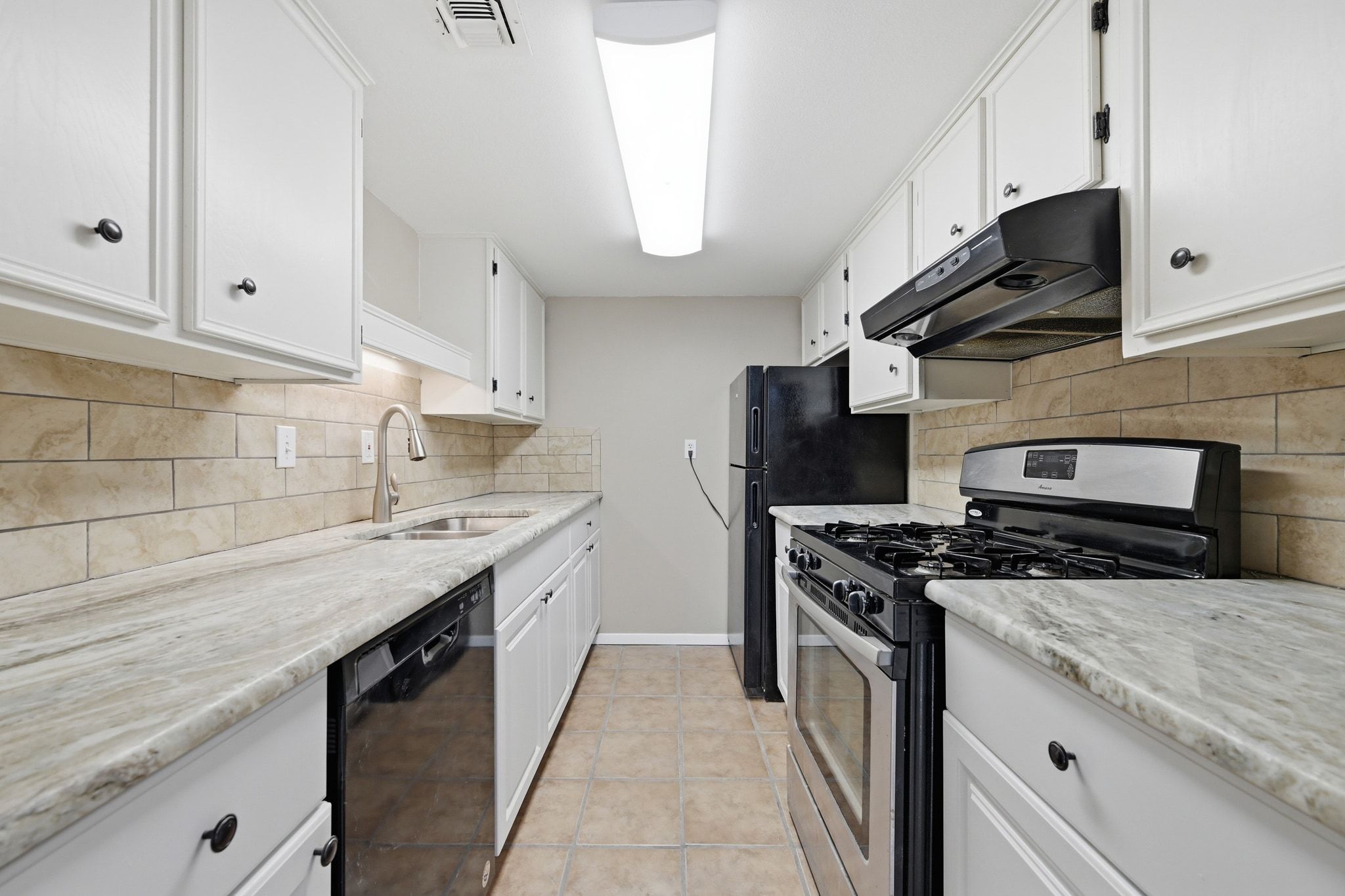 1800 Lavaca Street, Unit 515 Austin, TX 78701 - Photo 6 of 20 a kitchen with stainless steel appliances granite countertop a sink stove and cabinets