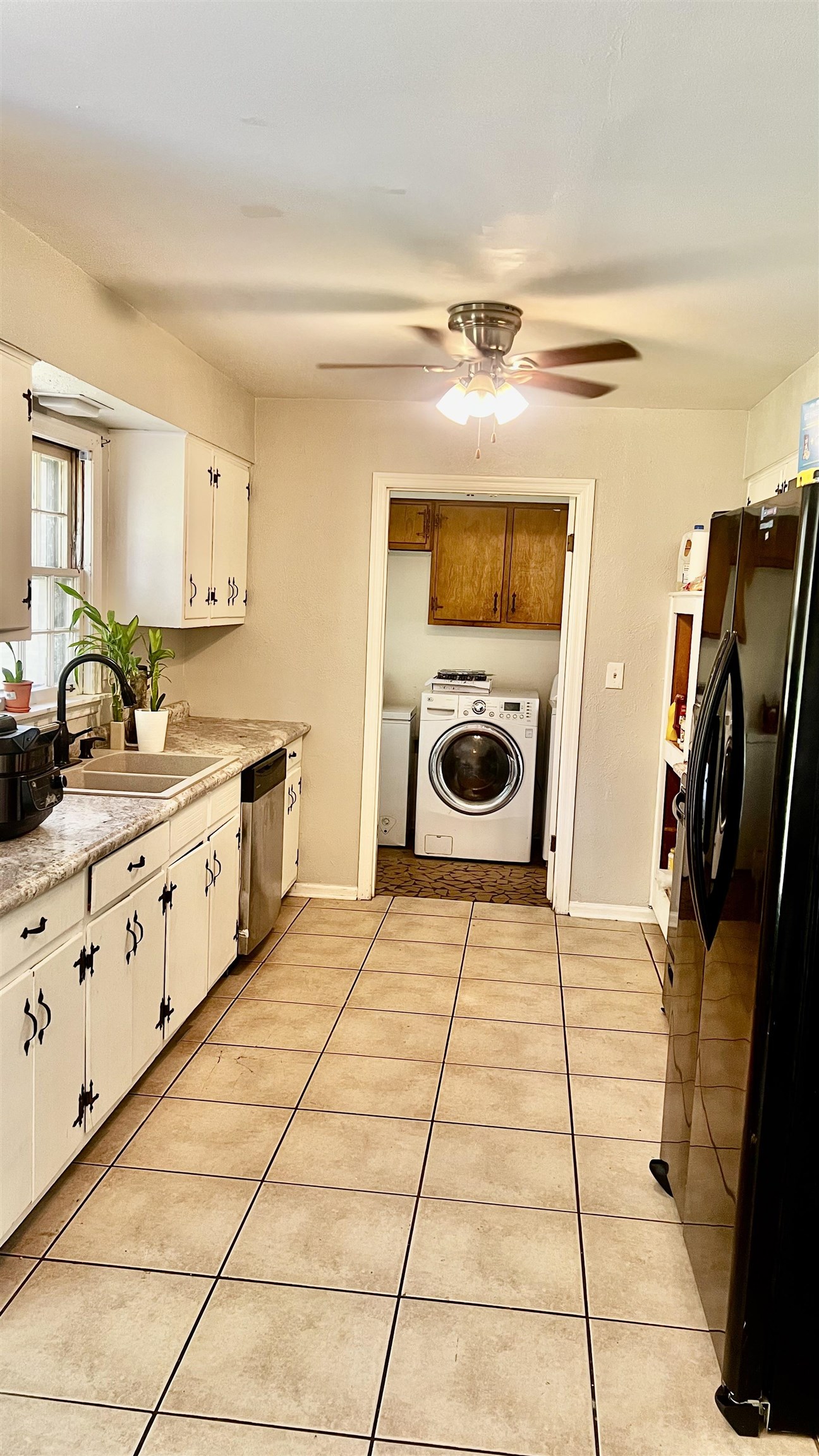 3122 Kirkcaldy Road Memphis, TN 38128 - Photo 13 of 16 Kitchen featuring white cabinetry, light tile flooring, ceiling fan, and black refrigerator