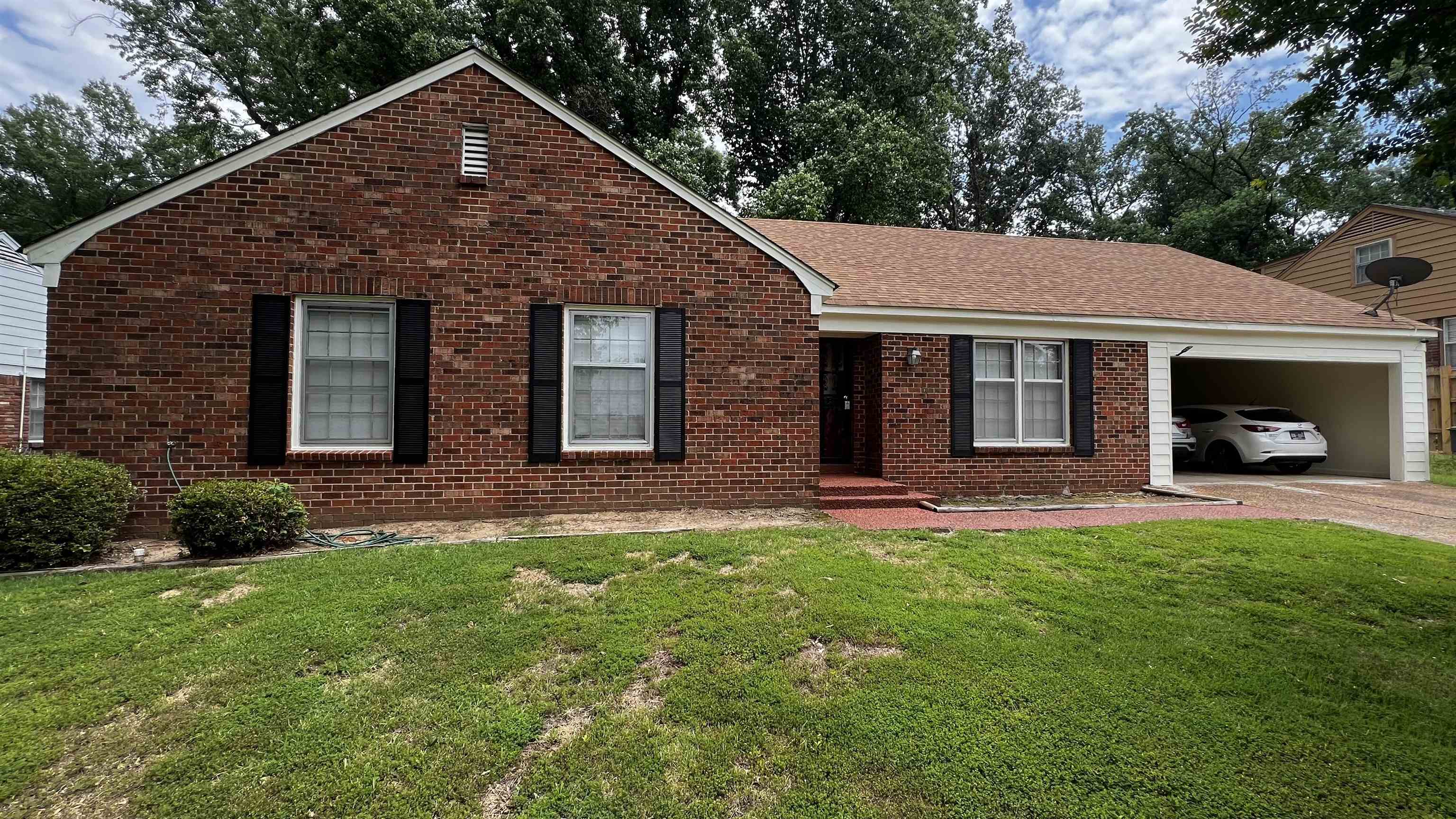 View of front of house featuring a garage and a front lawn