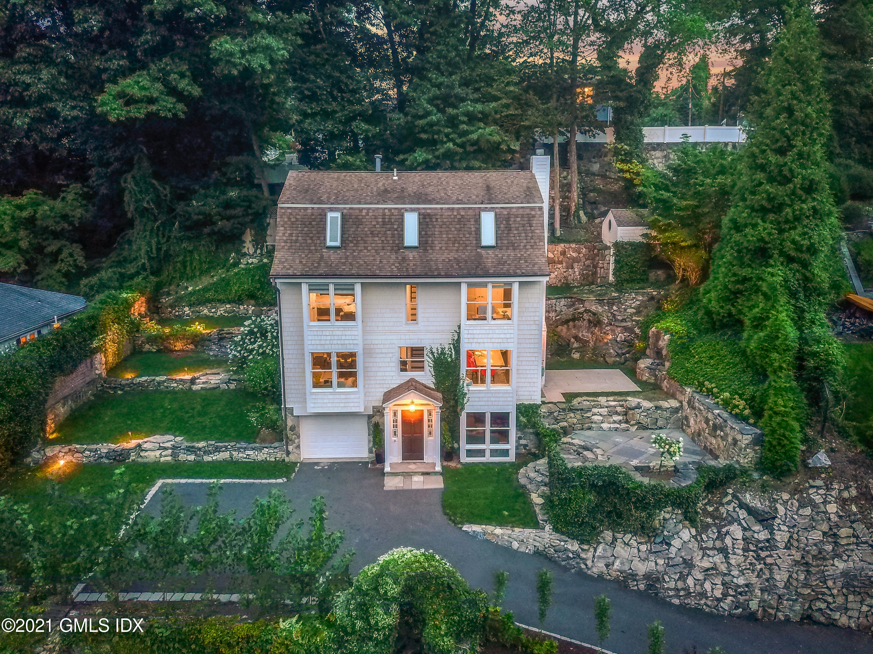 316 Valley Road Cos Cob, CT 06807 - Photo 1 of 25 an aerial view of a house with a yard and large tree