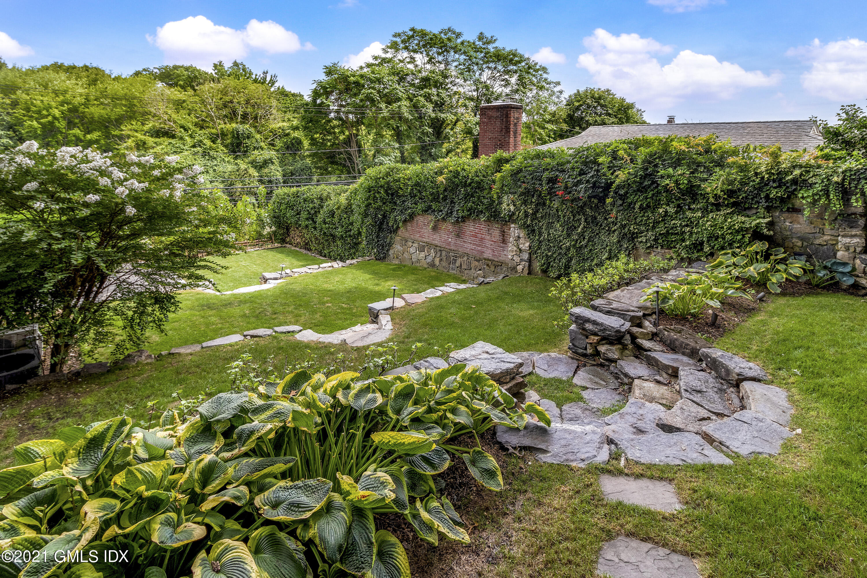 316 Valley Road Cos Cob, CT 06807 - Photo 22 of 25 a view of a garden with a tree