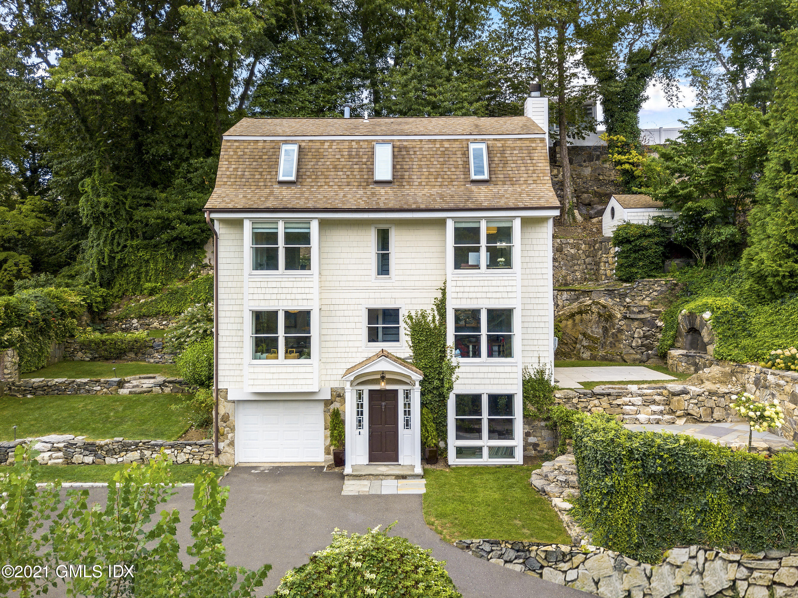 316 Valley Road Cos Cob, CT 06807 - Photo 24 of 25 a front view of a house with a yard