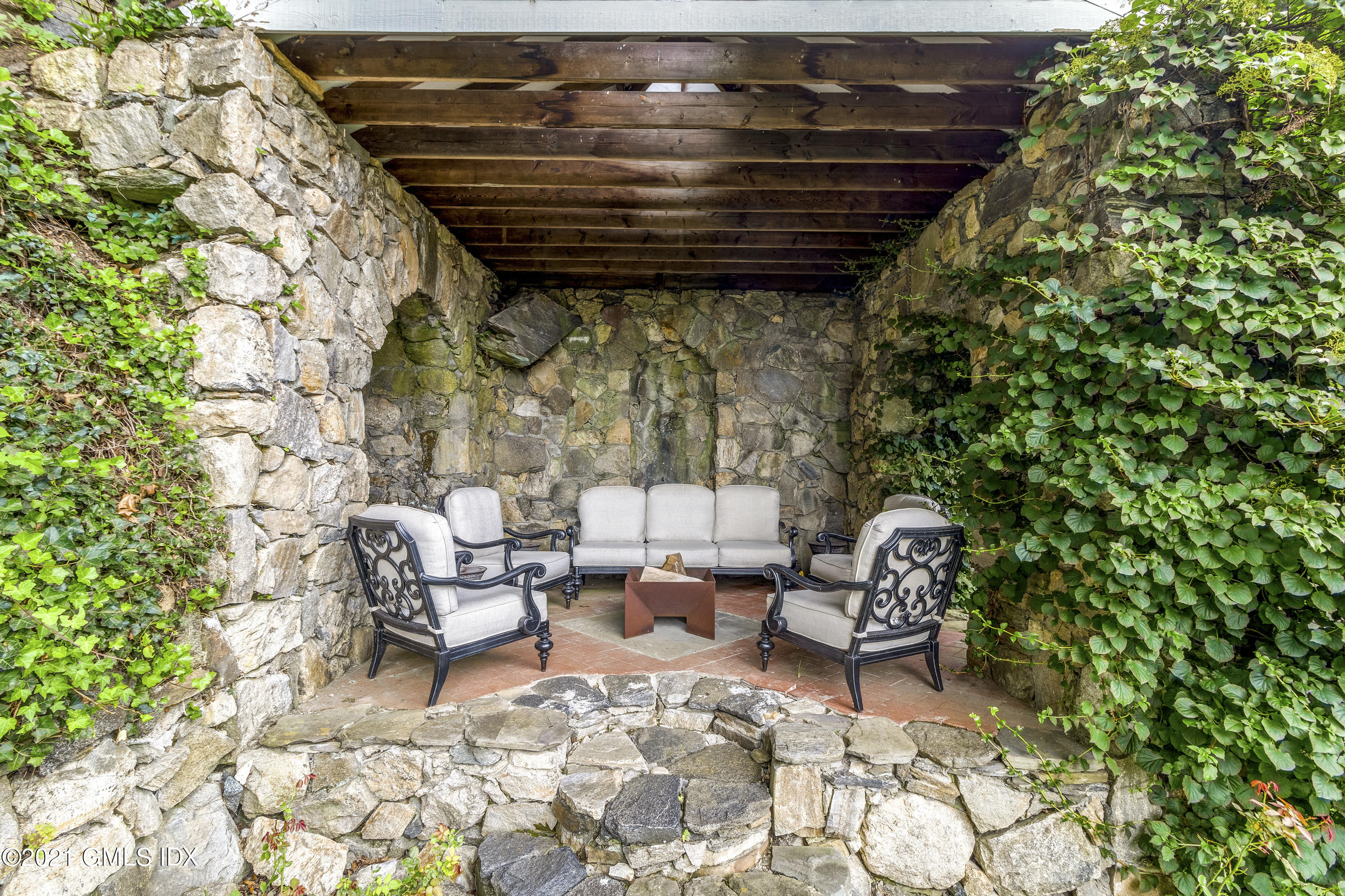 316 Valley Road Cos Cob, CT 06807 - Photo 25 of 25 a patio with table and chairs and potted plants