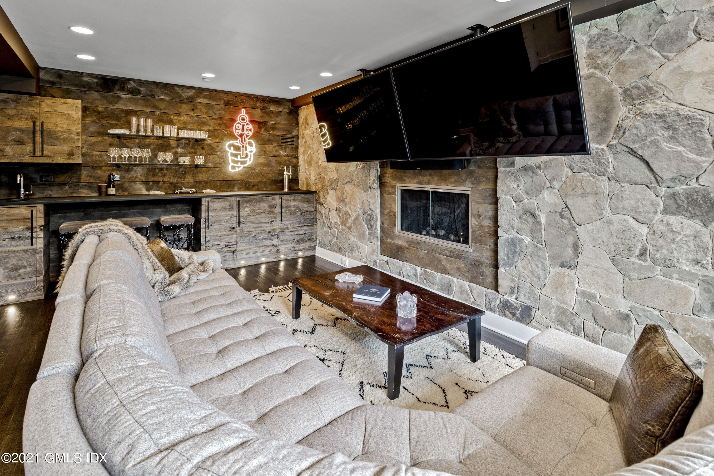 316 Valley Road Cos Cob, CT 06807 - Photo 3 of 25 a living room with furniture a flat screen tv and a fireplace