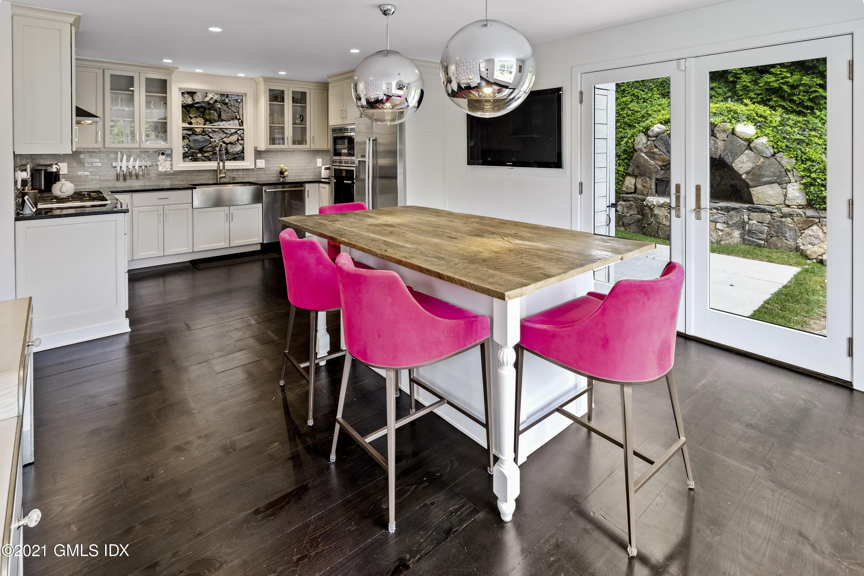 316 Valley Road Cos Cob, CT 06807 - Photo 6 of 25 a kitchen with a table chairs sink and cabinets