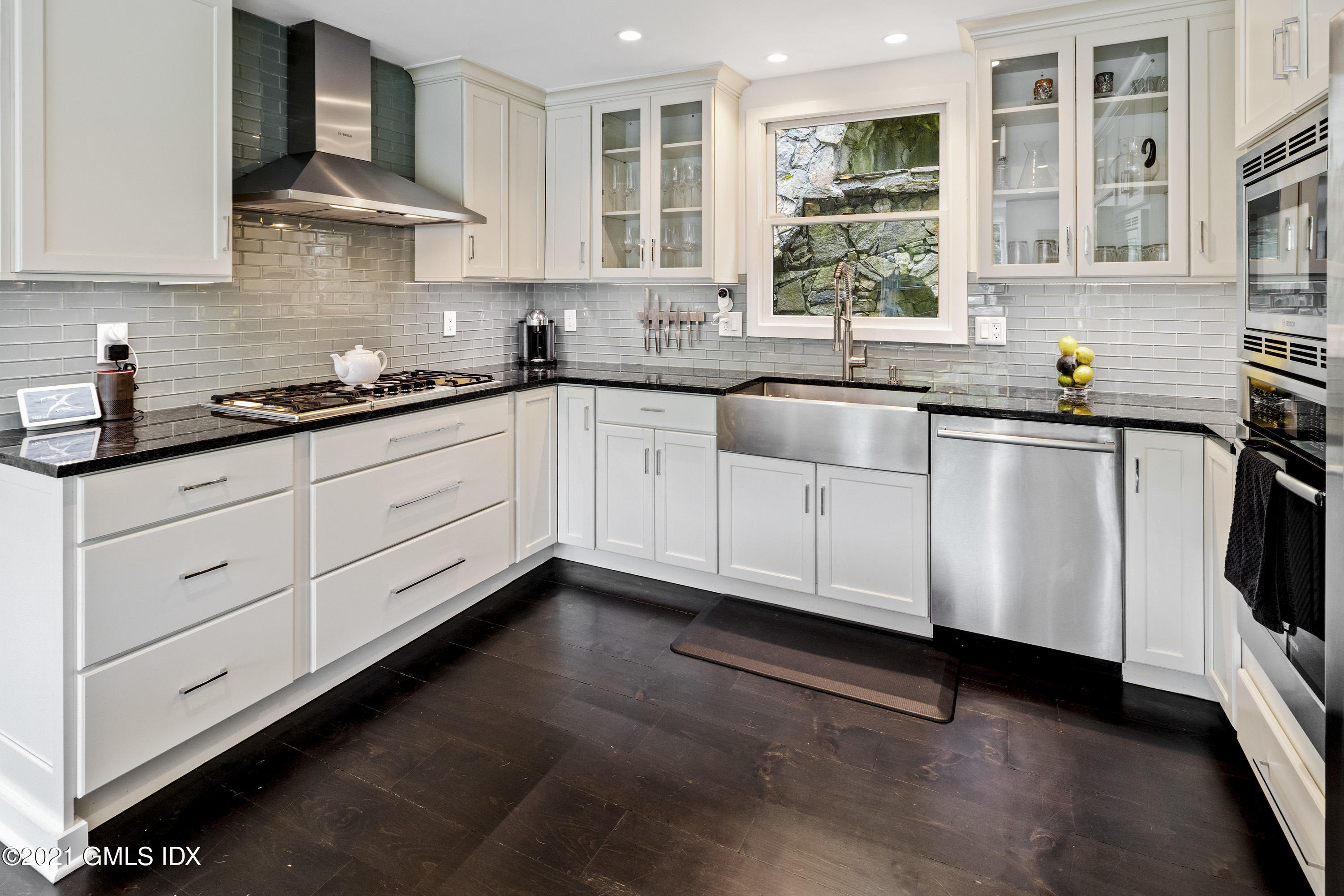 316 Valley Road Cos Cob, CT 06807 - Photo 7 of 25 a kitchen with granite countertop white cabinets and appliances