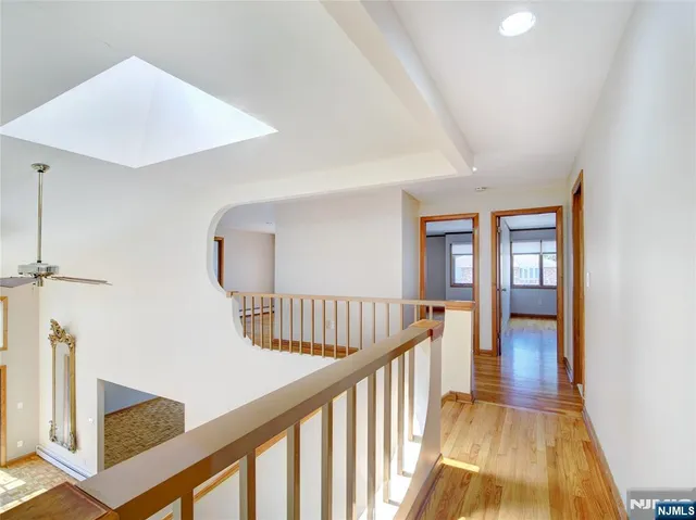 a view of staircase with railing and white walls