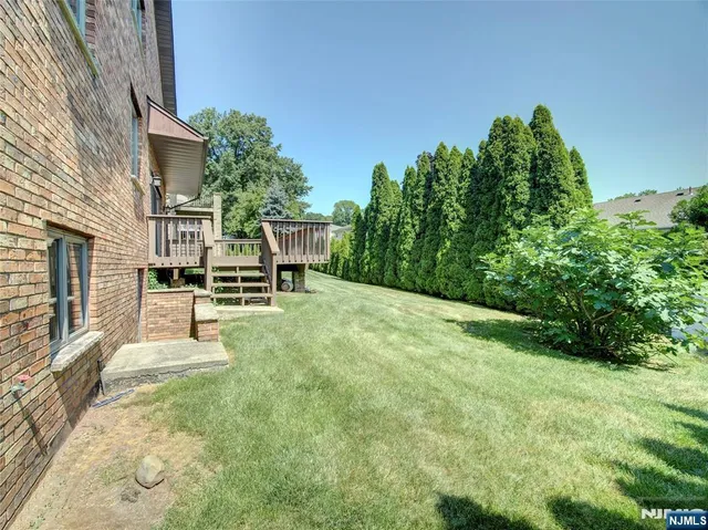 a view of house with outdoor space porch and garden