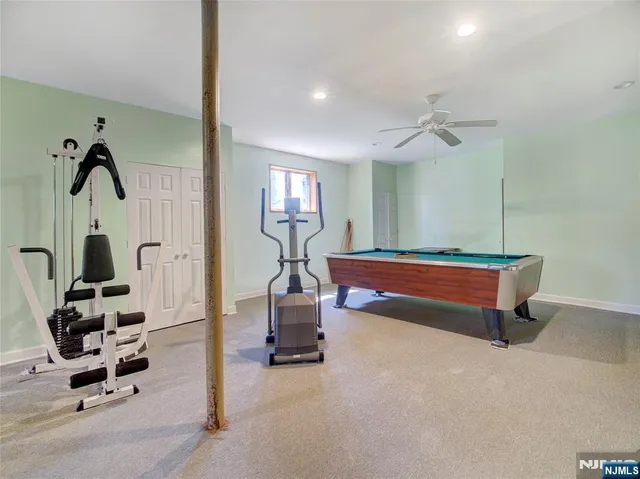 a room with gym equipment and view of living room