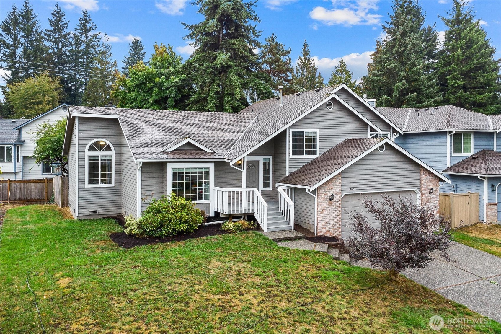 604 213th Street Southwest Bothell, WA 98021 - Photo 3 of 40 a view of a yard in front of a house with plants and large tree