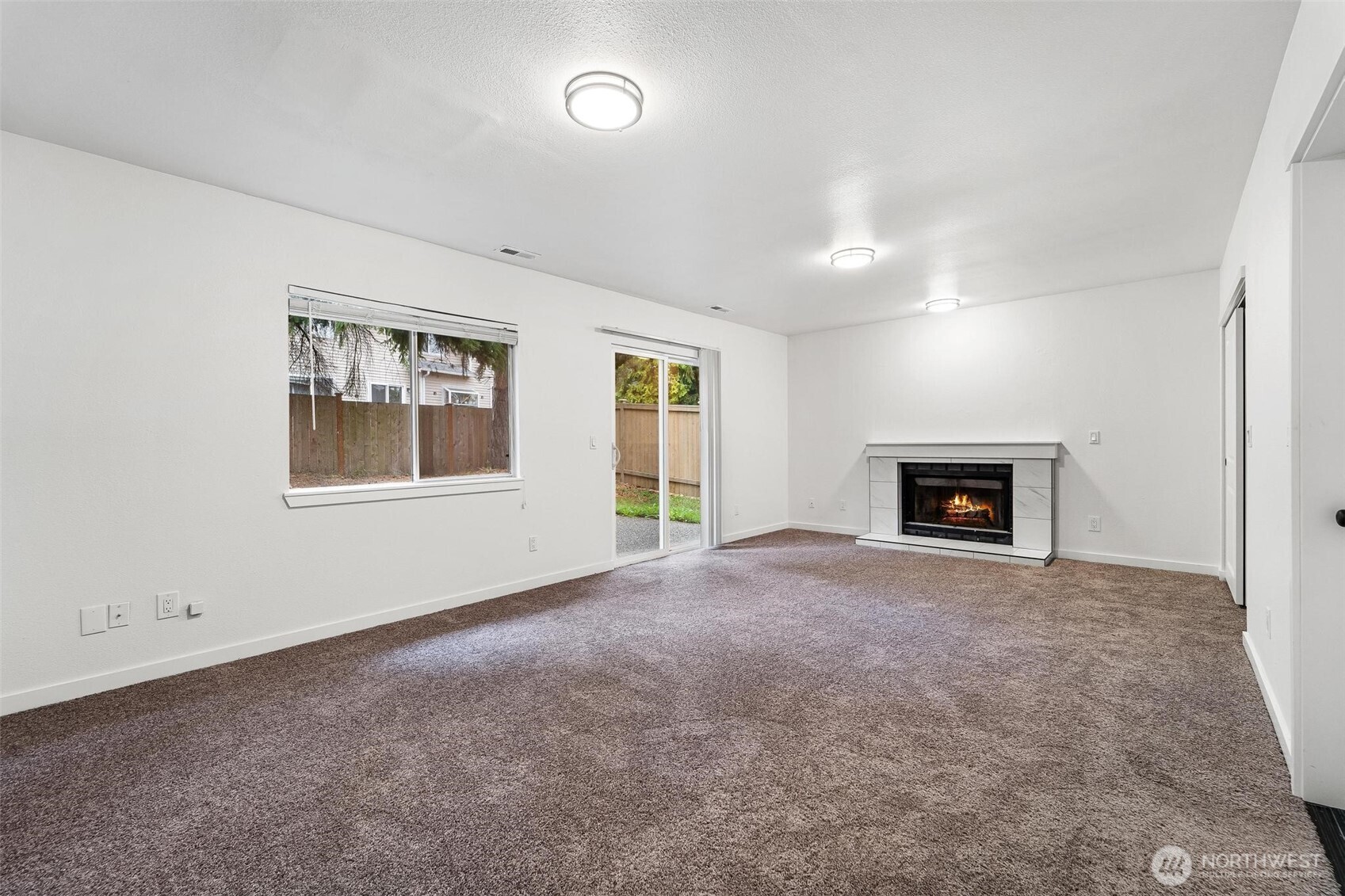 604 213th Street Southwest Bothell, WA 98021 - Photo 31 of 40 an empty room with windows and fireplace