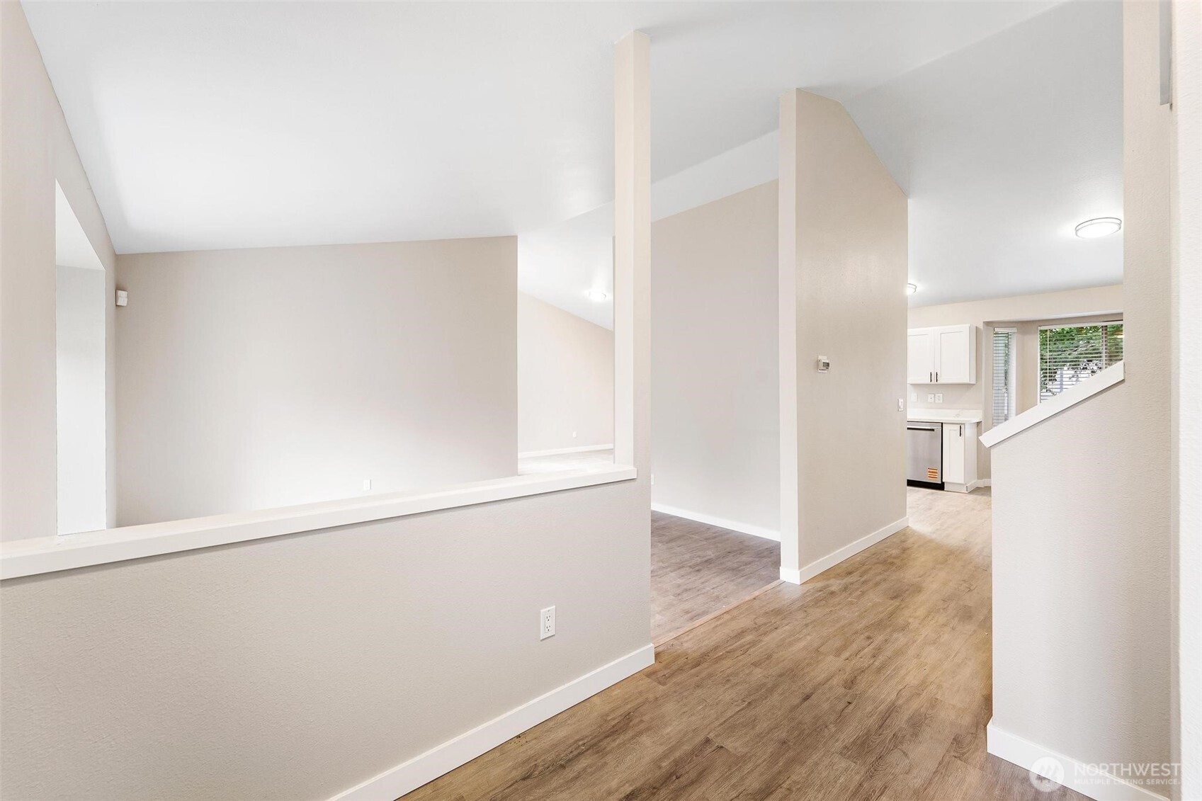 604 213th Street Southwest Bothell, WA 98021 - Photo 7 of 40 an empty room with wooden floor and windows
