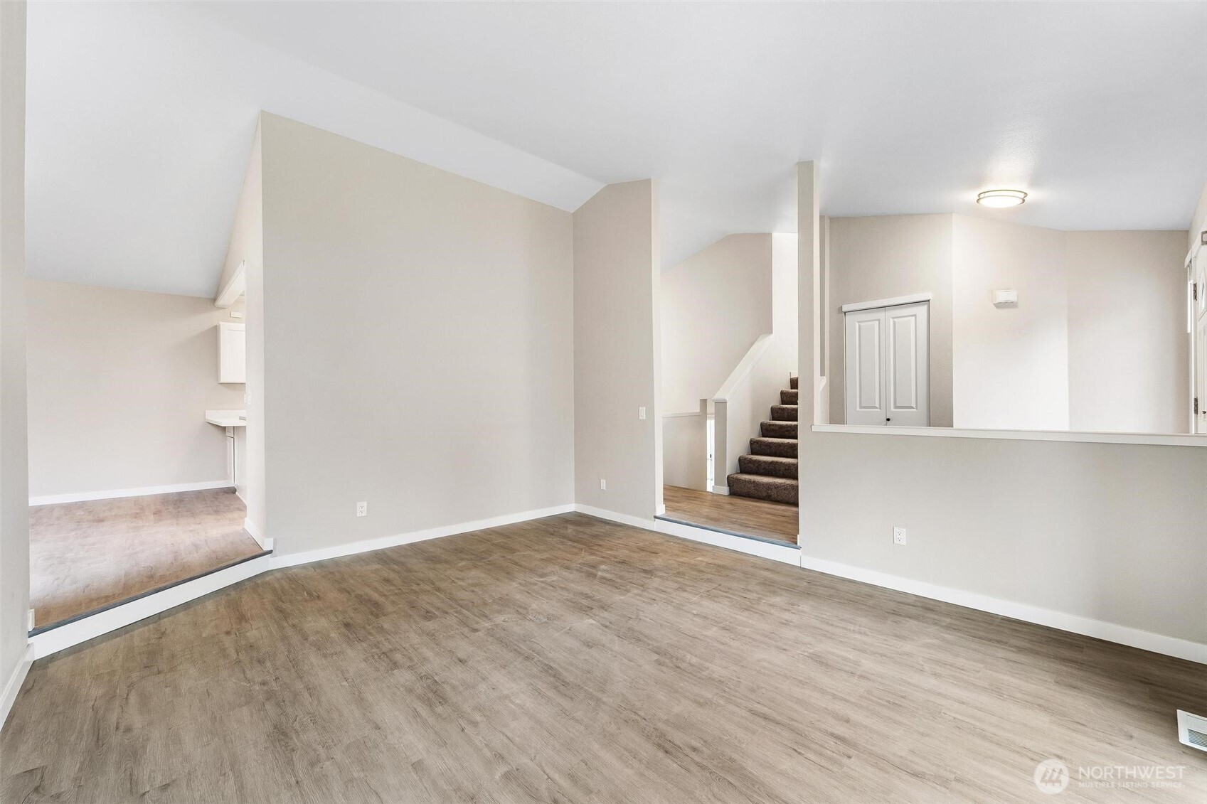 604 213th Street Southwest Bothell, WA 98021 - Photo 10 of 40 a view of a hallway with wooden floor and entryway