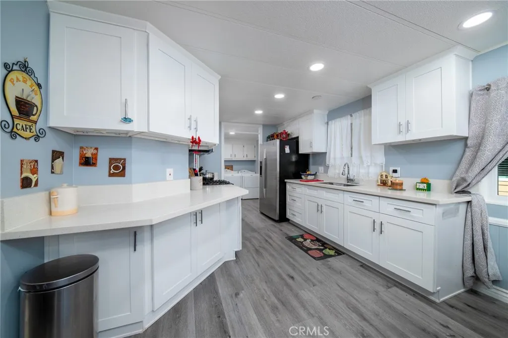 4000 Pierce Street, Unit 58 Riverside, CA 92505 - Photo 13 of 32 a kitchen with cabinets a sink and appliances