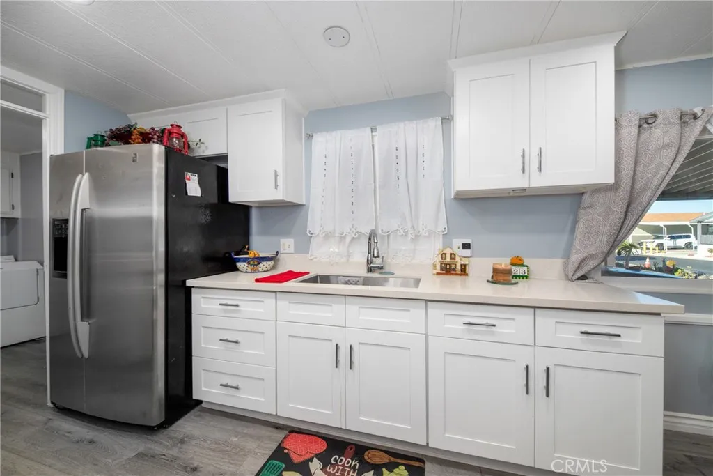 4000 Pierce Street, Unit 58 Riverside, CA 92505 - Photo 15 of 32 a kitchen with cabinets and stainless steel appliances