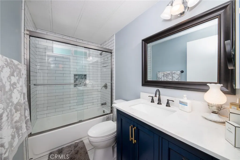 4000 Pierce Street, Unit 58 Riverside, CA 92505 - Photo 19 of 32 a bathroom with a sink a toilet a mirror and shower