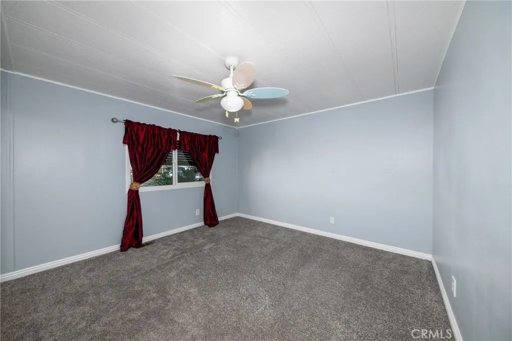 4000 Pierce Street, Unit 58 Riverside, CA 92505 - Photo 20 of 32 a view of a room with wooden floor and a ceiling fan