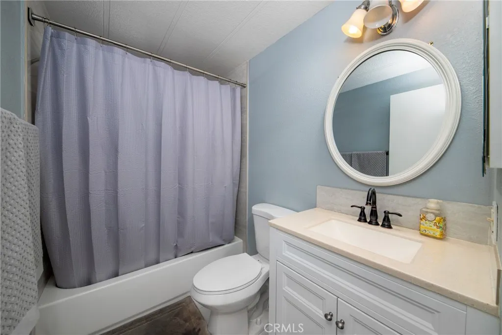 4000 Pierce Street, Unit 58 Riverside, CA 92505 - Photo 22 of 32 a bathroom with a sink a toilet and a mirror