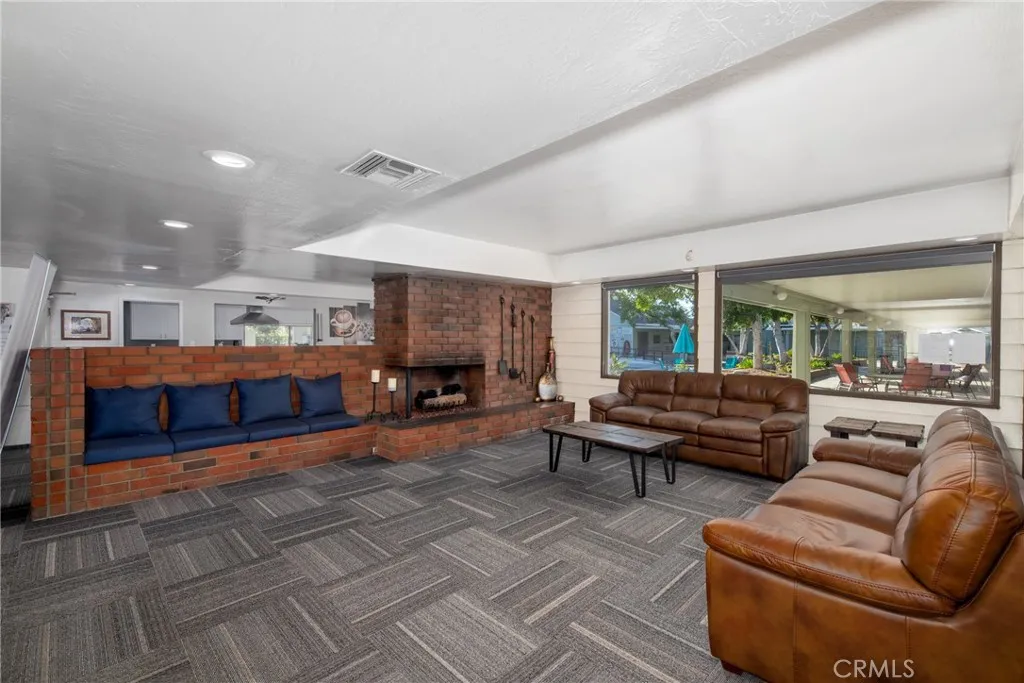 4000 Pierce Street, Unit 58 Riverside, CA 92505 - Photo 24 of 32 a living room with furniture and a fireplace