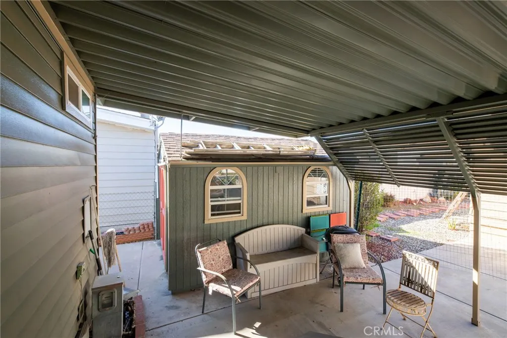 4000 Pierce Street, Unit 58 Riverside, CA 92505 - Photo 6 of 32 a patio with table and chairs and potted plants
