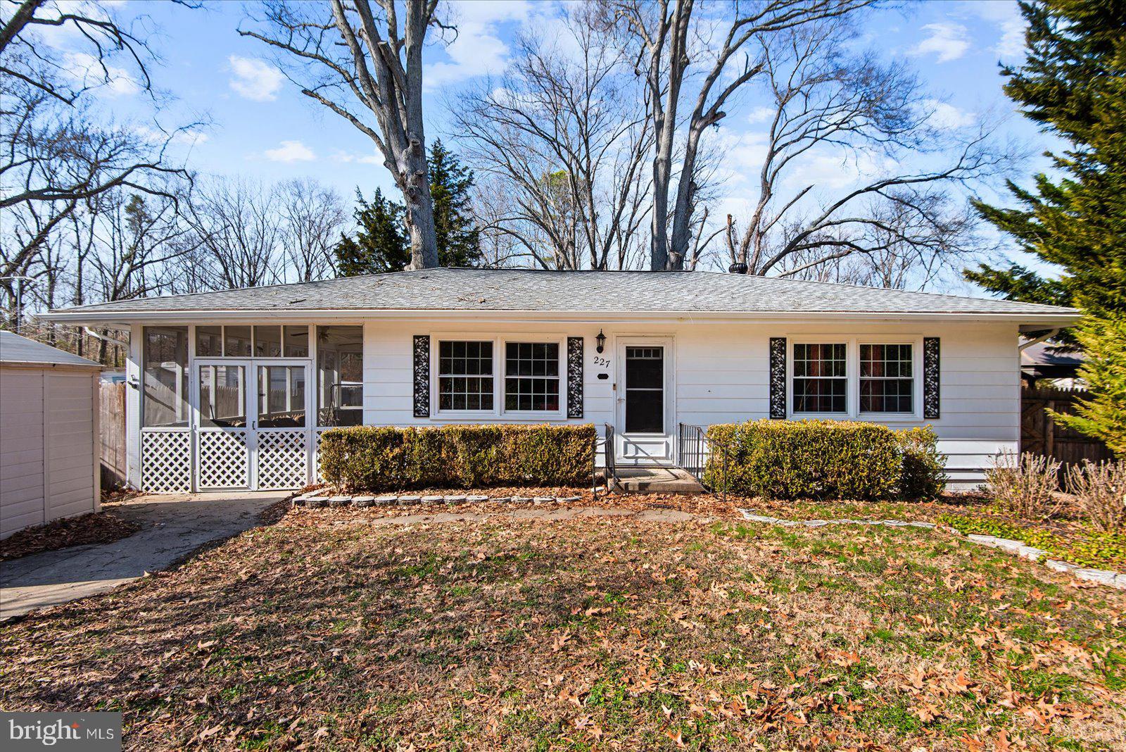 a front view of a house with a yard covered in snow