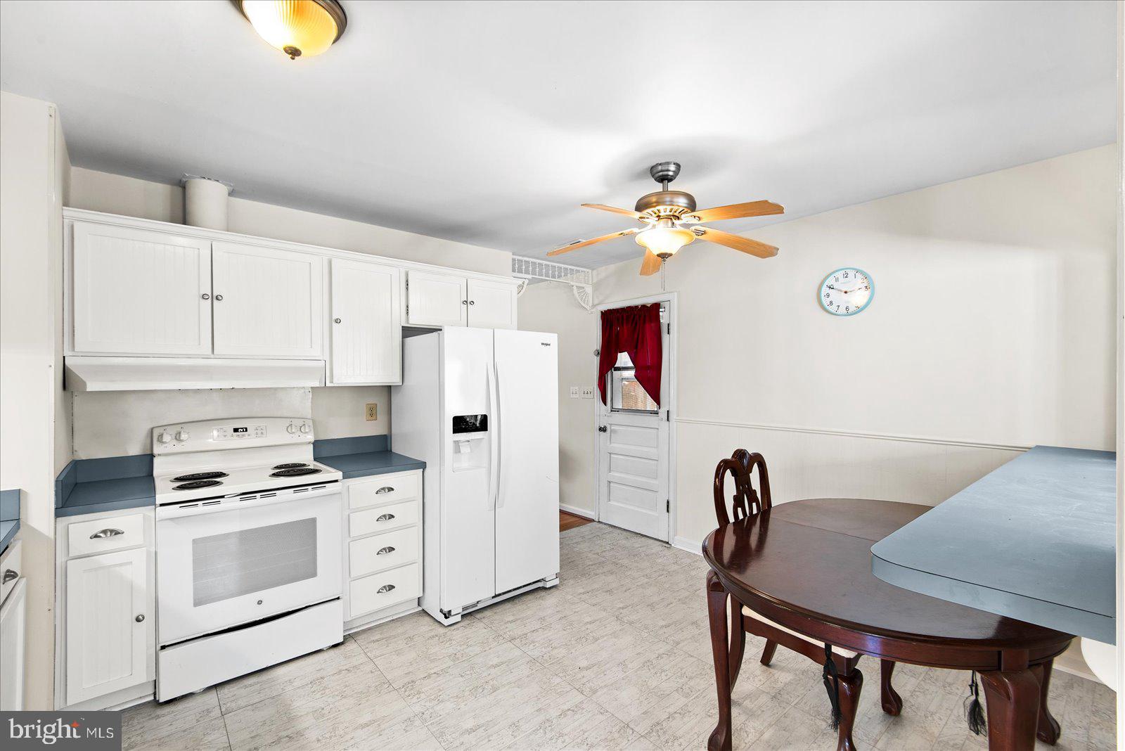 227 7th Street Colonial Beach, VA 22443 - Photo 14 of 36 a kitchen that has a cabinets a stove a dining table and chairs