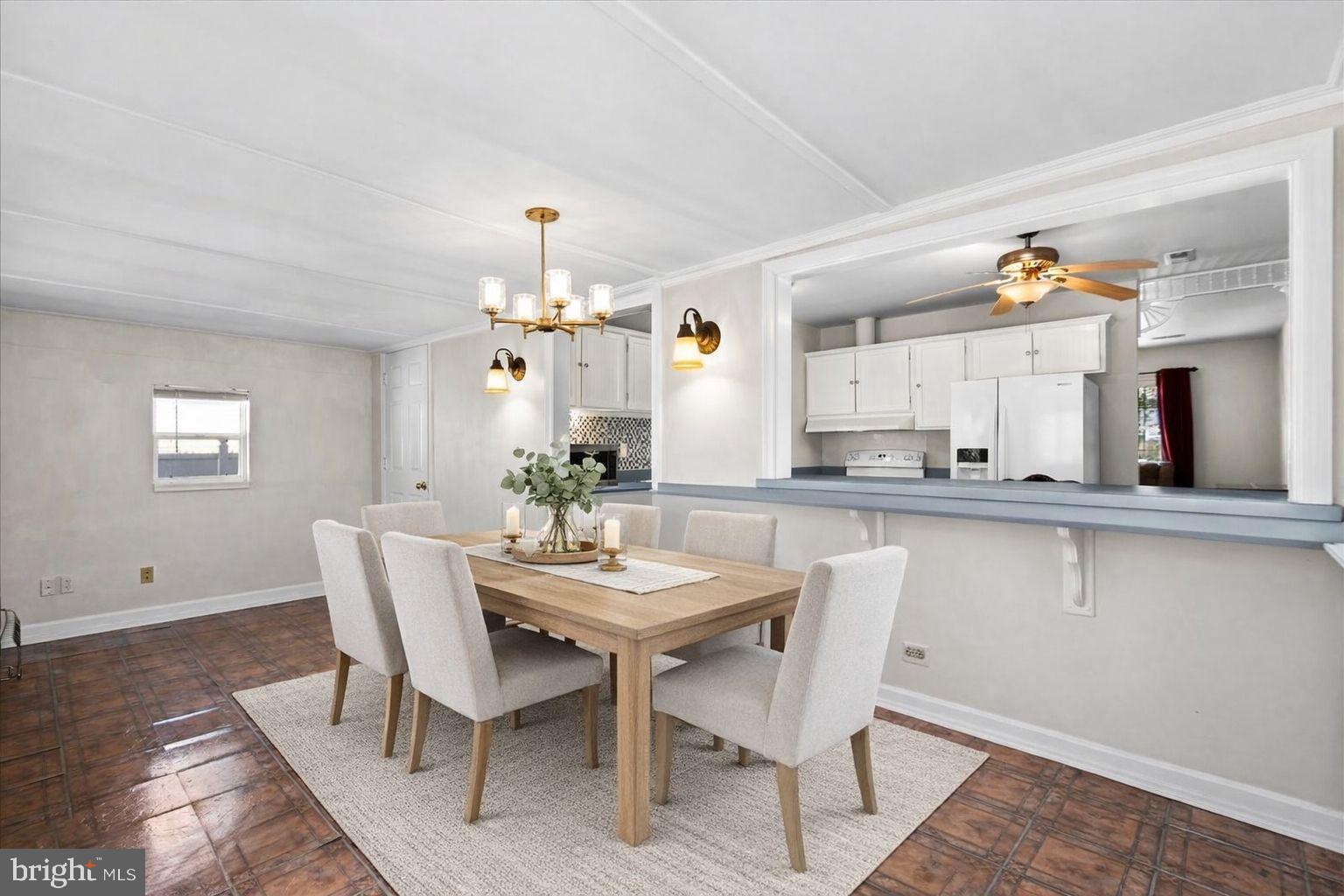 227 7th Street Colonial Beach, VA 22443 - Photo 16 of 36 a view of a dining room with furniture and chandelier