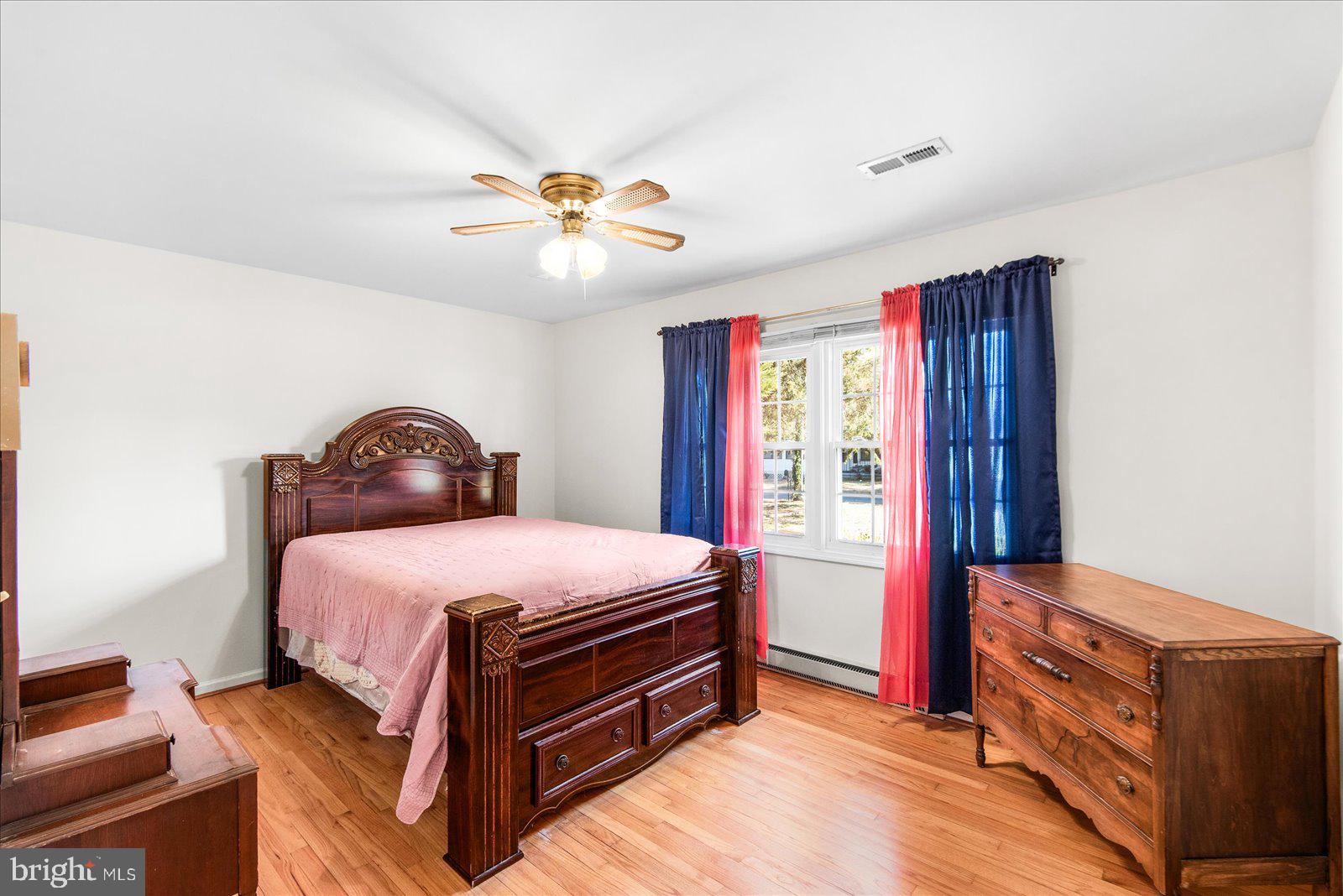 227 7th Street Colonial Beach, VA 22443 - Photo 17 of 36 a bedroom with a bed and a chandelier