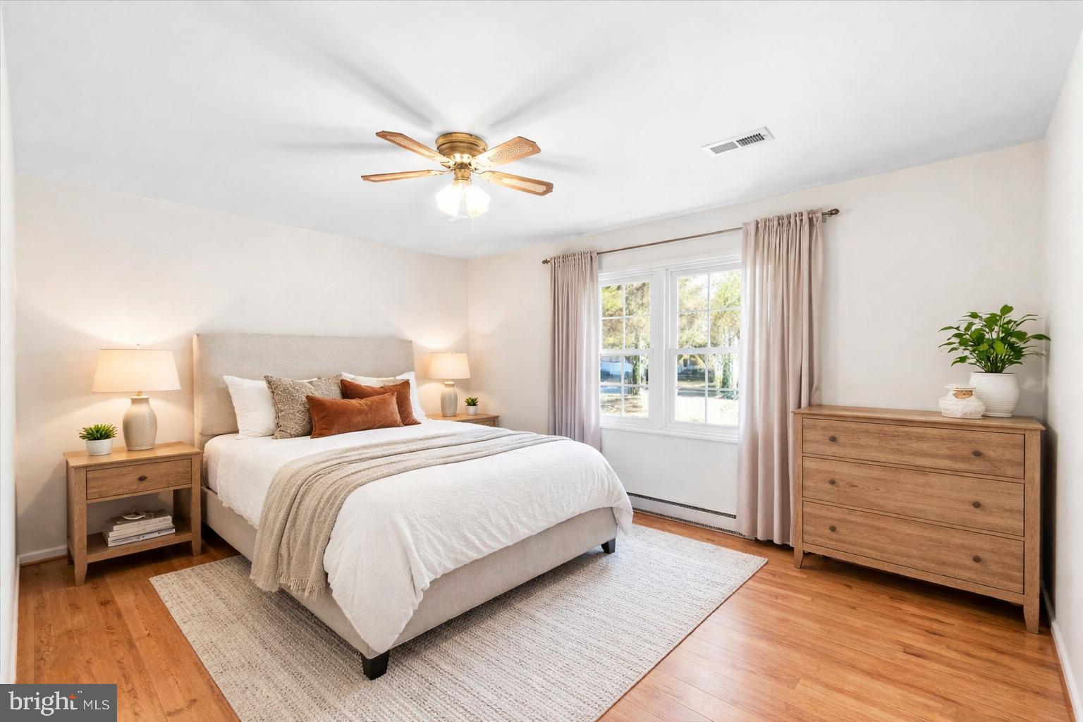 227 7th Street Colonial Beach, VA 22443 - Photo 18 of 36 a bedroom with a bed and a chandelier