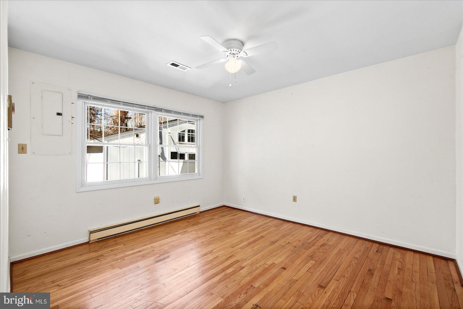 227 7th Street Colonial Beach, VA 22443 - Photo 20 of 36 a view of an empty room with wooden floor and a window