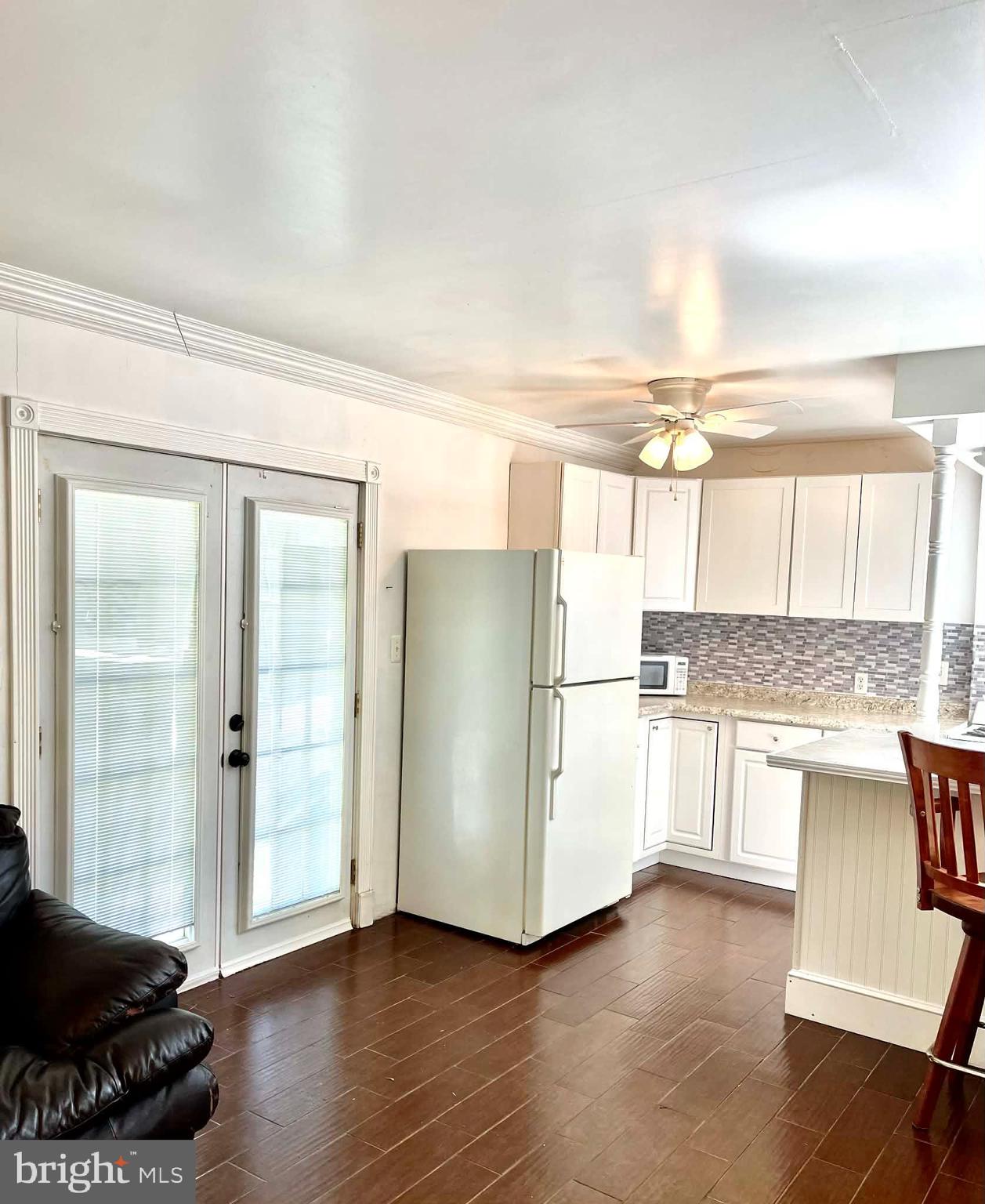 227 7th Street Colonial Beach, VA 22443 - Photo 23 of 36 a kitchen with a refrigerator and a stove top oven