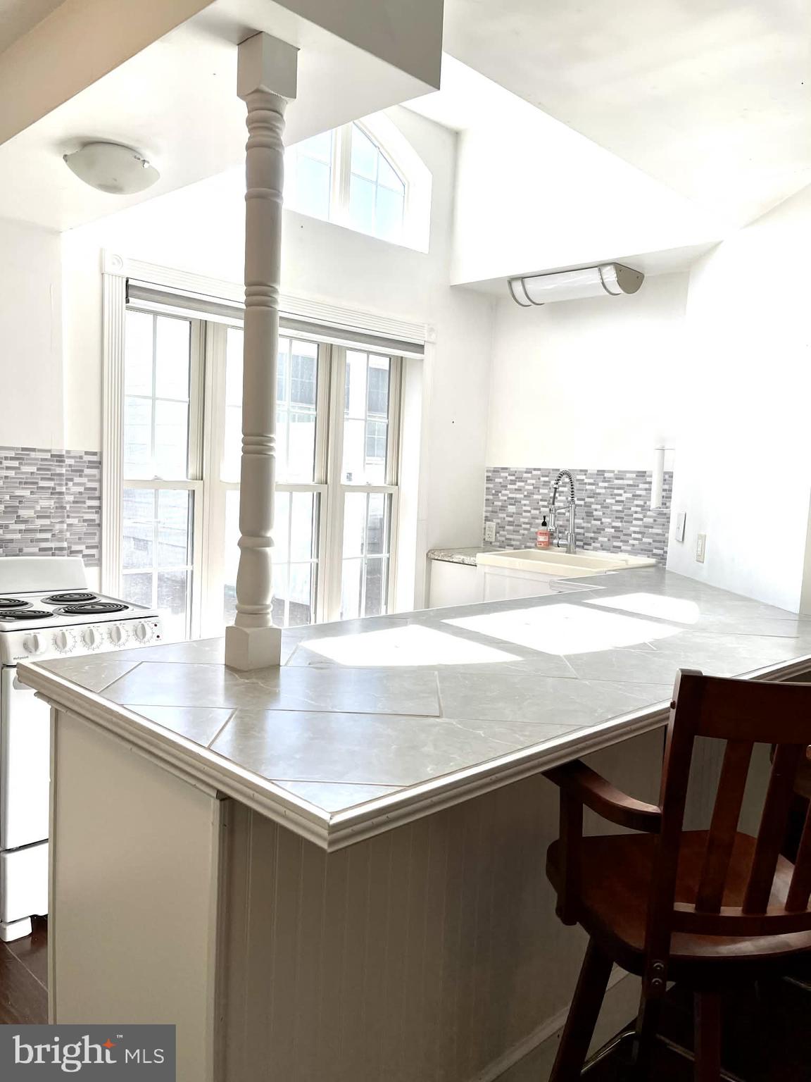 227 7th Street Colonial Beach, VA 22443 - Photo 25 of 36 a view of a kitchen with granite countertop a sink and a stove